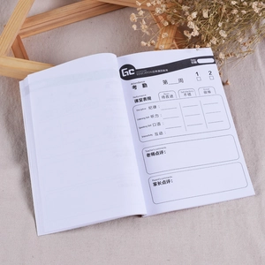 Detail view of bilingual kraft paper notebook showing attendance and performance logs