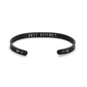 Detail view of black titanium steel cuff bracelet with "BEST BITCHES" engraving