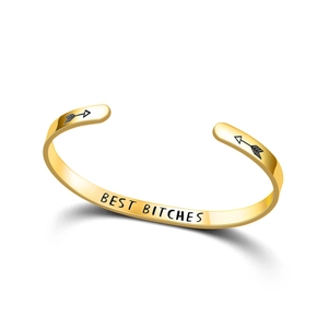 Detailed view of gold stainless steel cuff bracelet with a Best Bitches engraving.