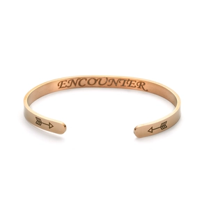 Detailed view of a rose gold titanium steel cuff bracelet with ENCOUNTER engraving