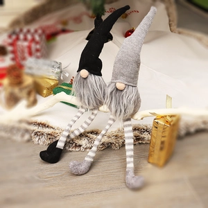 Christmas long-legged gnome dolls in black and grey sitting on festive white branches