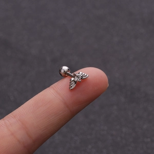 Macro shot of stainless steel butterfly tragus stud with clear zircon and ball back