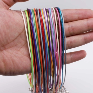Detalle de collares de cordón encerado de varios colores con cierres de mosquetón y extensión
