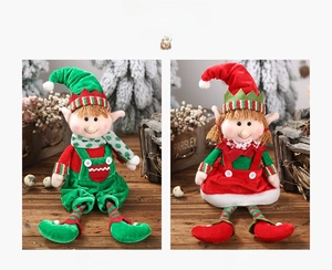 Detail view of male and female Christmas elf dolls in green and red plush outfits