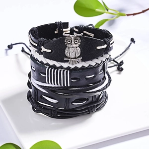 Vintage braided leather bracelet set with silver owl charm on a decorative plate