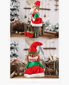 Side and back view of a plush Christmas elf doll with striped hat in a cozy rustic setting