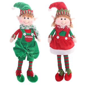 Pair of red and green Christmas elf plush dolls with striped socks on white background