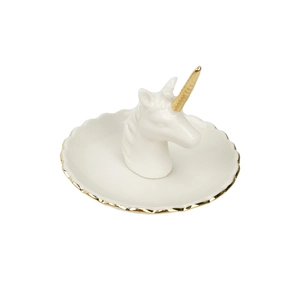 Macro view of white ceramic jewelry tray with a gold-edged unicorn head centerpiece