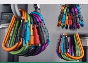 Macro detail of multi-colored D-ring aluminum carabiners with secure screw lock mechanism