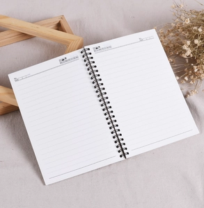 Macro view of horizontal lined pages and date section in a spiral-bound notebook