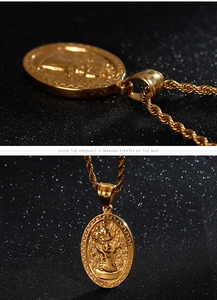 Macro shot of gold Virgin Mary pendant with detailed engraving on twisted rope chain
