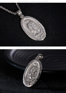 Macro detail of silver Virgin Mary oval pendant and twisted rope chain necklace