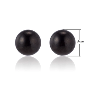 Close-up of 5mm black spherical stud earrings with polished finish and smooth surface