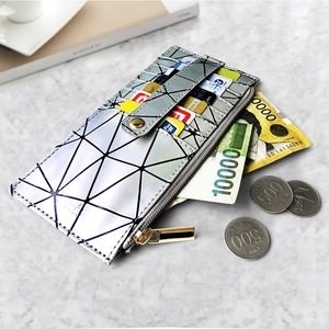 Detailed view of silver geometric patchwork long wallet with zipper on marble table