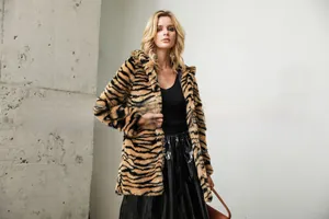 Detail of the winter faux fur coat showing thick tiger print texture and mid-length fit