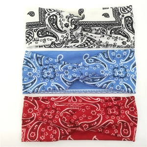 Three-pack of paisley twisted headbands in black, blue, and red for yoga and sports