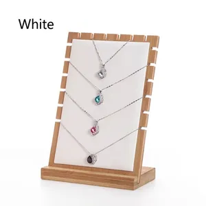 Detail of wooden display stand holding four necklaces with multi-colored gemstone pendants