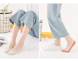 Detail view of light green and orange no-show socks featuring a thin breathable knit texture