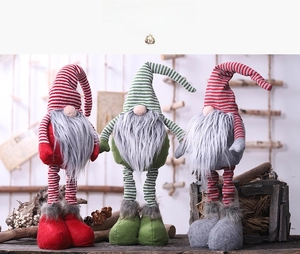 Close-up of three Christmas gnomes with striped retractable legs and long plush beards