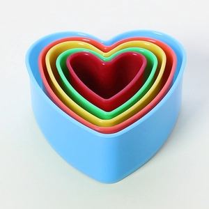 Detailed view of 5-piece colorful heart-shaped plastic cookie cutters in nested sizes
