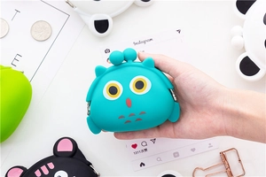 Detailed view of turquoise owl silicone coin purse with metal ball clasp closure