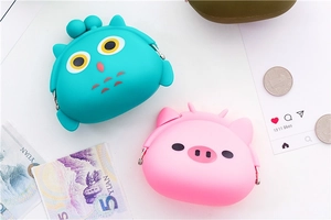 Close-up of cute animal silicone coin purses with metal clasps in owl and pig shapes