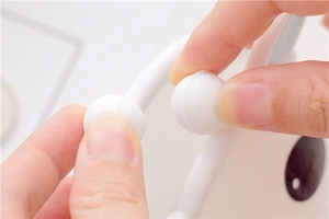 Detailed close-up of the spherical clasp closure on a cute white silicone coin purse