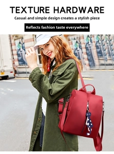 Red nylon casual backpack with cute cat charm shown during outdoor street style use