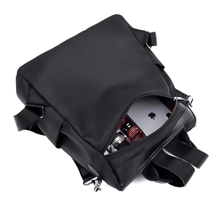 Minimalist black nylon backpack with silver zippers and spacious storage compartments