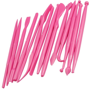 Pink plastic 14-piece set of cake decorating and sculpting tools on white background