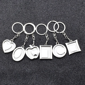 Set of 6 metal keychain frames in various shapes including heart and round for DIY photos