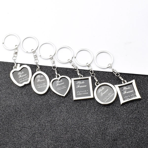 Various silver metal photo frame keychains in heart, round, and square shapes