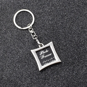 Top view of square metal photo frame keychain showing 2.9cm dimensions on dark texture