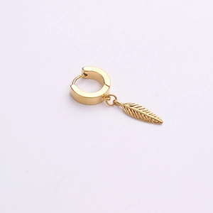 Close-up of gold stainless steel huggie hoop earring with a detailed feather pendant