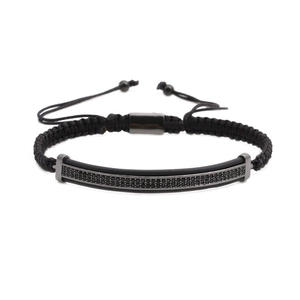 Macro shot of men's black braided bracelet with micro-pave black zircon metal plate