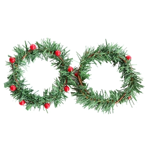 Artificial Christmas wreath candle holder with red berries and green pine needles on white base