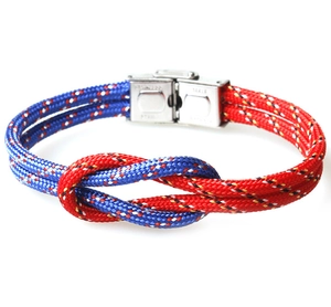 Close-up of blue and red braided paracord bracelet with a polished magnetic metal clasp