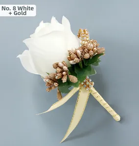 Detailed view of white silk rose boutonniere with gold berries and rhinestone accents