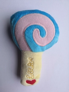 Detailed view of plush lollipop dog toy featuring soft blue fabric and Lollipop embroidery
