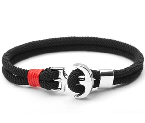 Detail of black paracord bracelet with red accents and a silver stainless steel anchor clasp