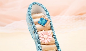Detailed macro view of peacock blue fabric and satin jewelry slots on high heel ring holder