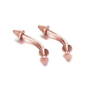 Macro shot of rose gold curved barbell body piercing studs with conical spikes and polished finish