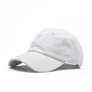Close-up of distressed white cotton baseball cap with ripped details and fabric texture