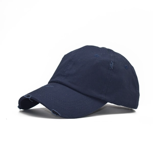 Detailed view of distressed navy cotton baseball cap with ripped brim and worn edges