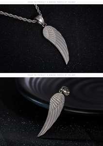 Macro detail of a silver feather pendant showing intricate texture and woven metal chain
