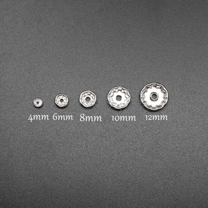Silver spacer beads for DIY jewelry making in five sizes 4mm to 12mm shown on grey background