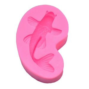 Detail view of pink silicone mold with koi fish pattern for candles and fondant