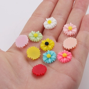 Macro shot of colorful 12mm resin daisy flowers for DIY hair accessories and crafts