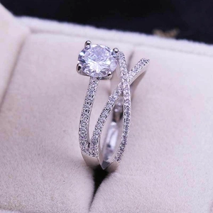 Macro shot of double-layer crisscross ring with large round-cut zircon and micro-pave diamonds