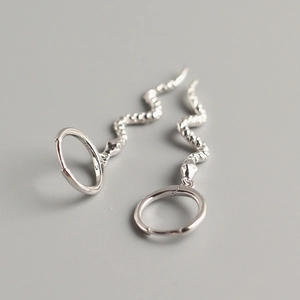 Macro detail of S925 sterling silver snake earrings showing hallmark and metal texture